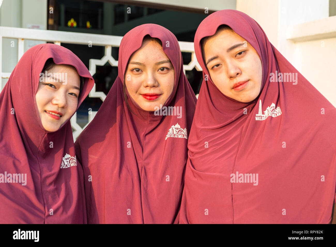 Chinese Women Tourists Visiting the Melaka Straits Mosque, Masjid Selat, the Floating Mosque, Melaka, Malaysia. Stock Photo