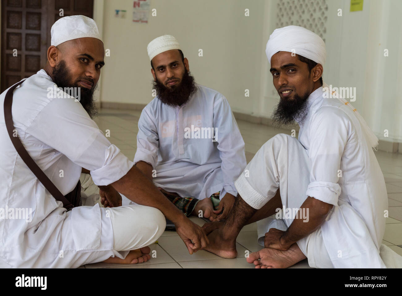 Bangladeshi Muslim Men at the Melaka Straits Mosque, Masjid Selat, the Floating Mosque, Melaka, Malaysia. Stock Photo