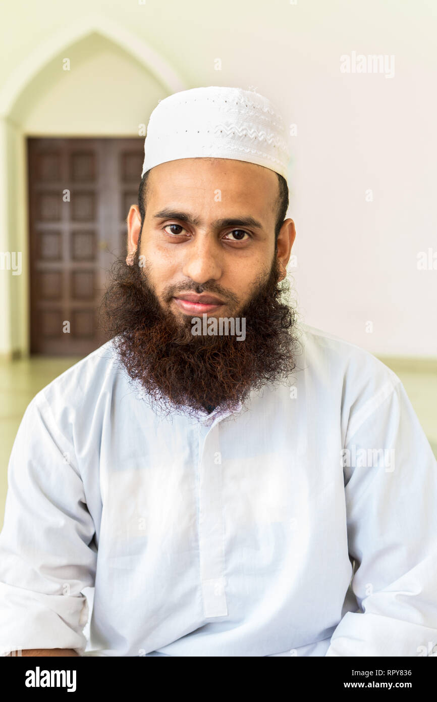 Bangladeshi Muslim Man at the Melaka Straits Mosque, Masjid Selat, the Floating Mosque, Melaka, Malaysia. Stock Photo