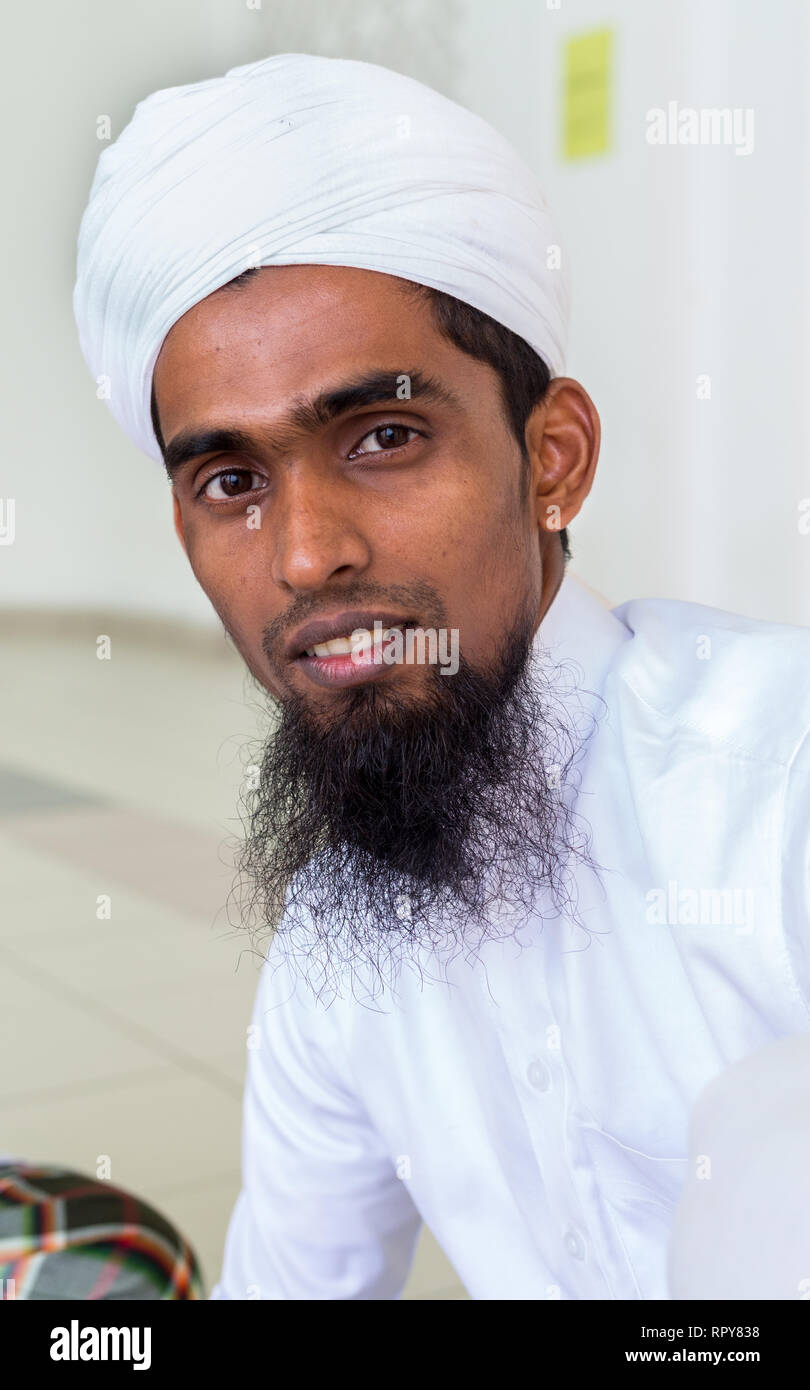 Bangladeshi Muslim Man at the Melaka Straits Mosque, Masjid Selat, the Floating Mosque, Melaka, Malaysia. Stock Photo