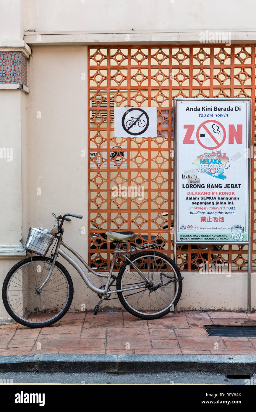 Sign Announcing No Smoking Prohibition in the Heritage Area; Sign Prohibiting Parking of Bicycles.  Melaka, Malaysia. Stock Photo