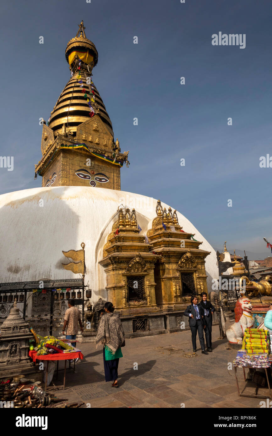Nepal, Kathmandu, Swayambhunath Temple, visitors at Swayambhu Stupa, by Buddha Akshobya and Vairocana Stock Photo