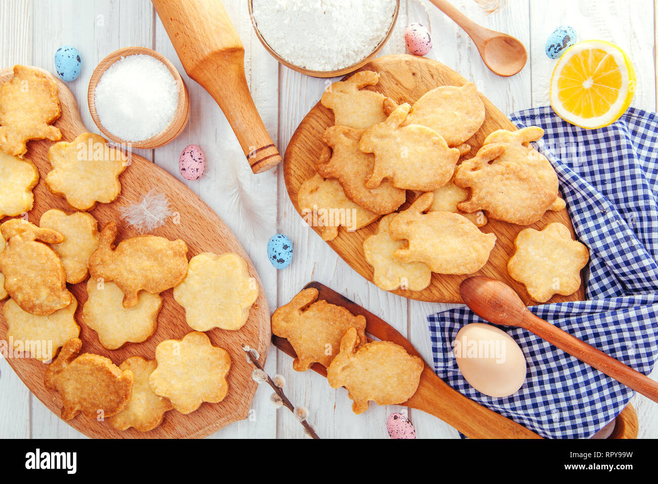 Happy Easter. Baking Easter bunnies. Ingredients with Easter decoration on wooden table Stock Photo