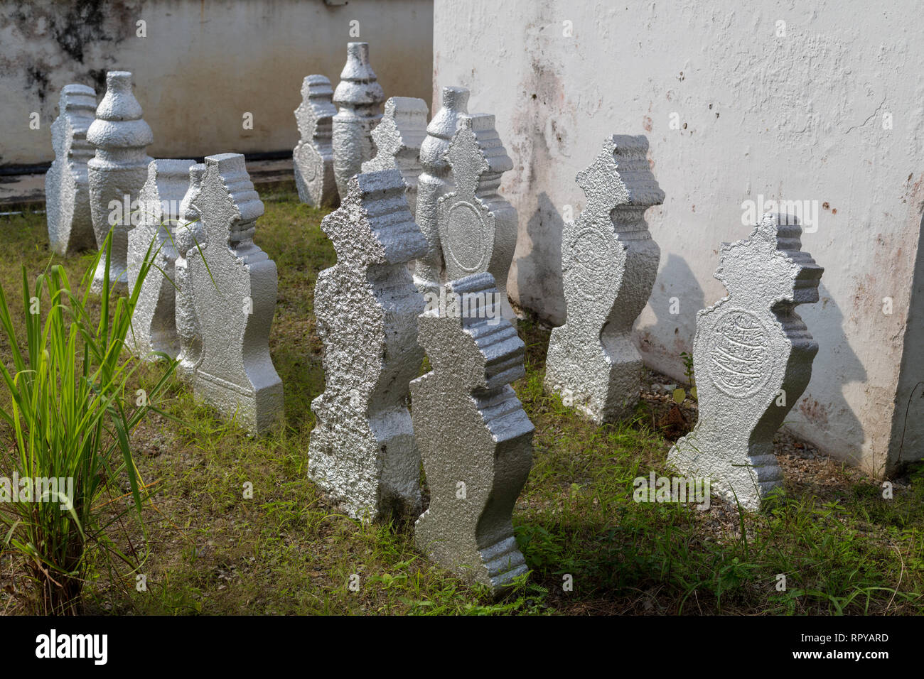 Gravestones in Cemetery of Kampung Kling Mosque, Melaka, Malaysia.  Round for men, shaped for women. Stock Photo