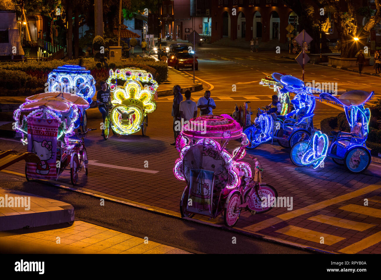 Trishaw Drivers Waiting for Tourist Customers at Night, Melaka, Malaysia. Stock Photo