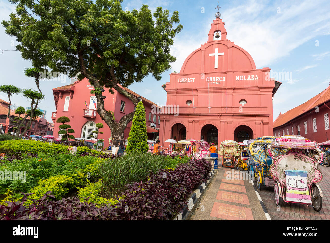 Trishaws Await Tourists in front of Christ Church, Built 1753, Melaka, Malaysia. Stock Photo