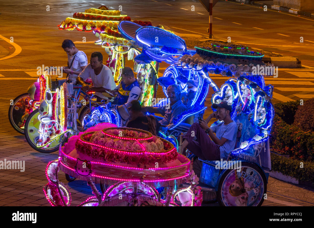 Trishaw Drivers Waiting for Tourists at Night, Melaka, Malaysia. Stock Photo