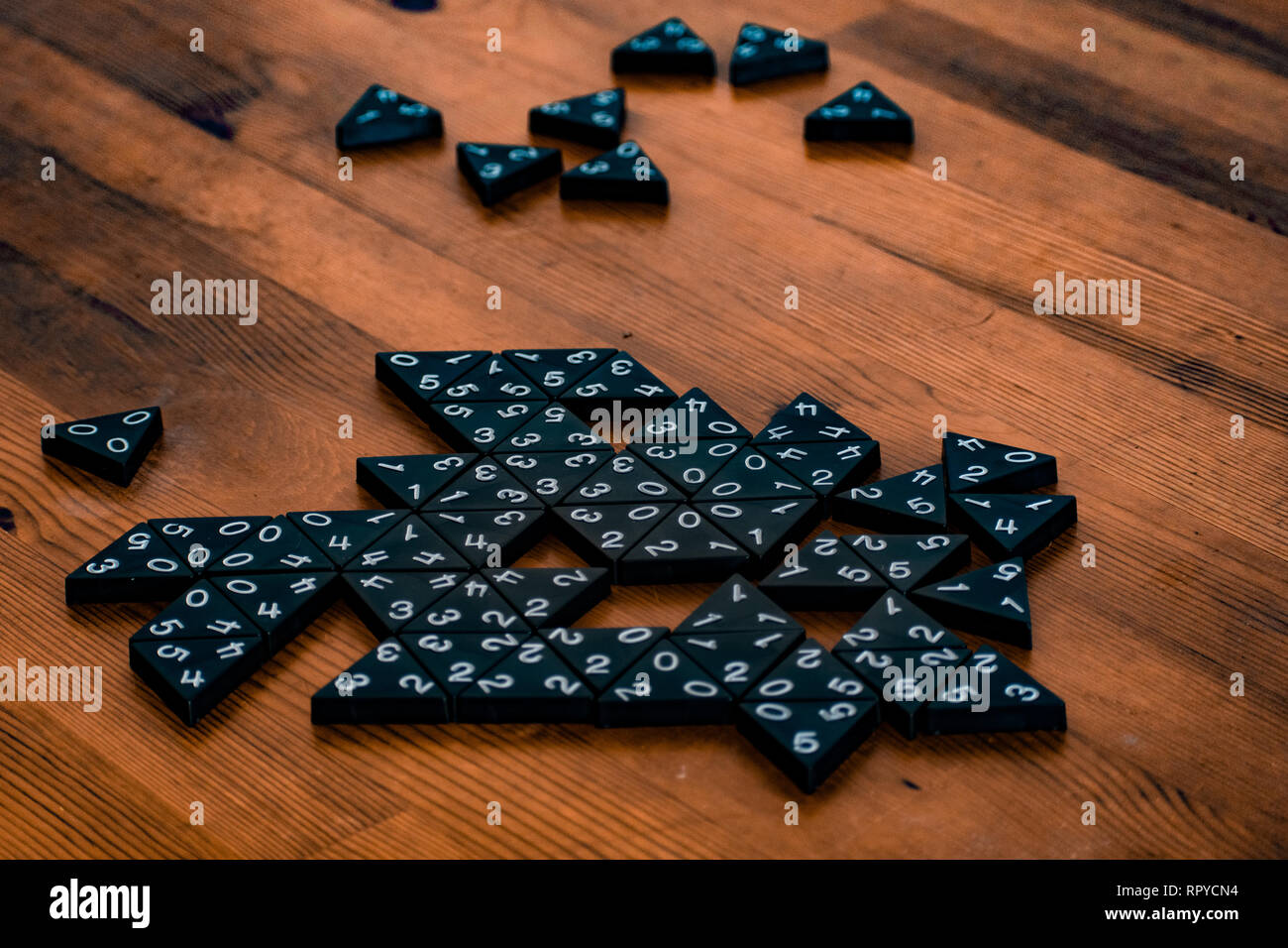 colored image of table game pieces scattered on deep grain table Stock Photo