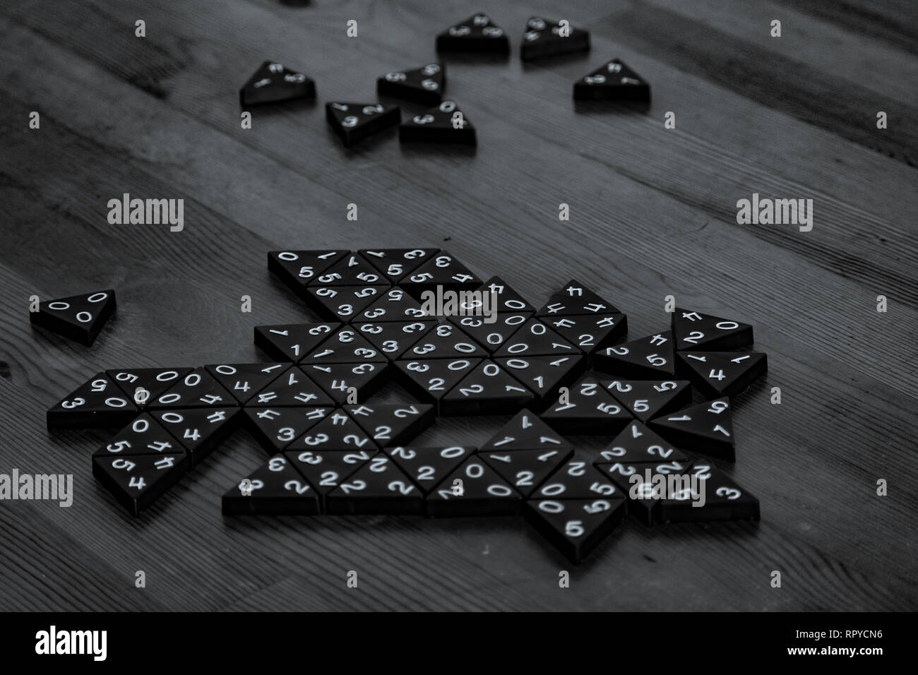 black and white photo of dominoes table game on high contrast wooden table Stock Photo