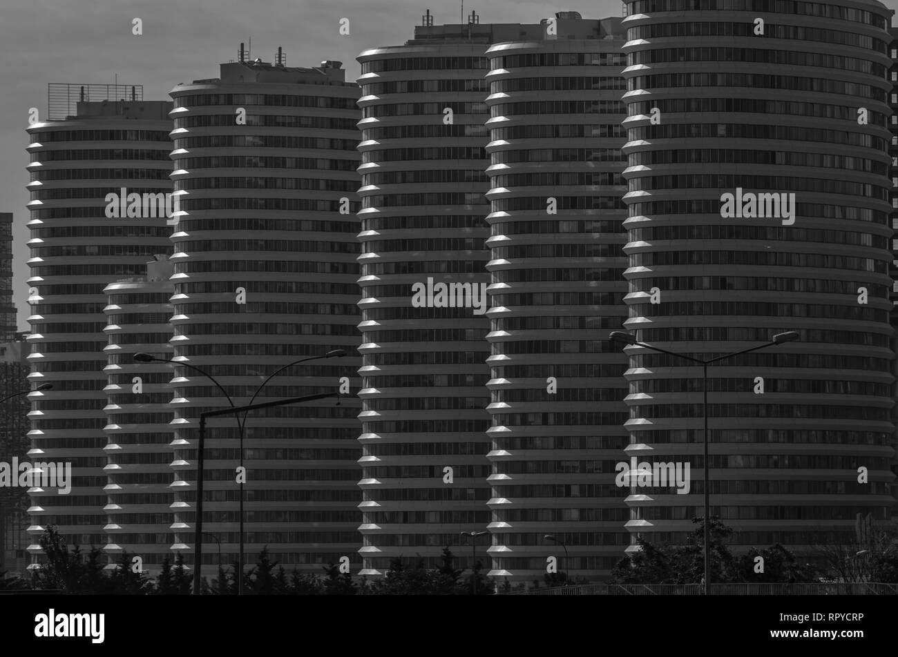 Five tall and one short building in a row in black and white composition. Stock Photo