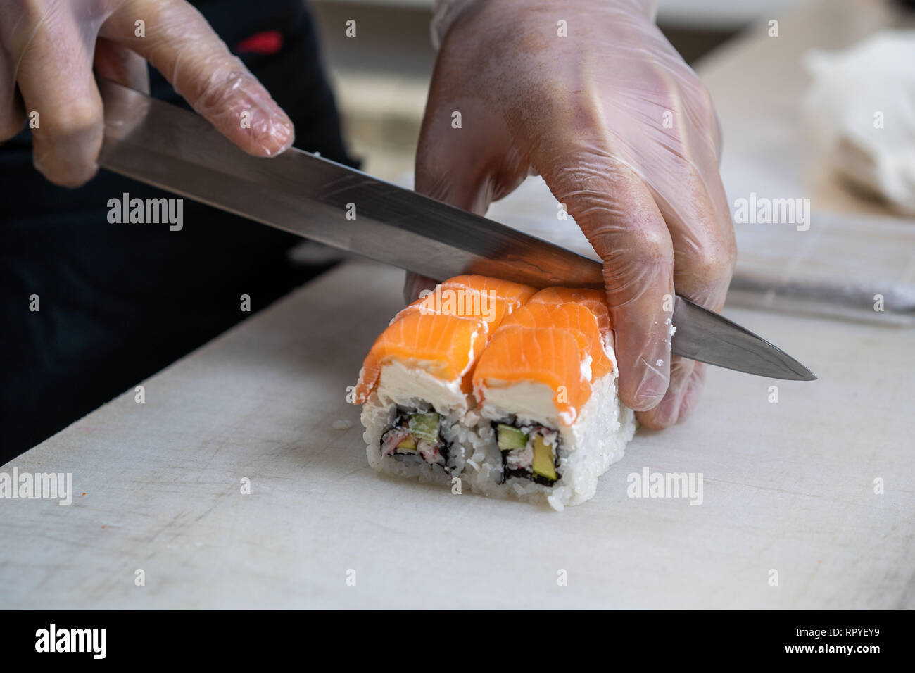 https://c8.alamy.com/comp/RPYEY9/cook-hands-making-japanese-sushi-roll-japanese-chef-at-work-preparing-delicious-sushi-roll-with-eel-and-avocado-appetizing-japanese-food-RPYEY9.jpg