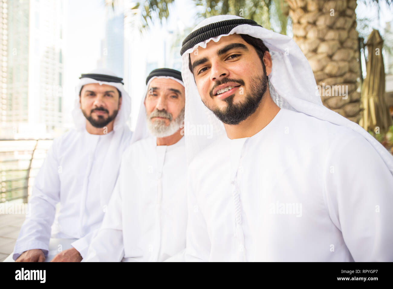 Group of arabian businessmen with kandura meeting outdoors in UAE ...