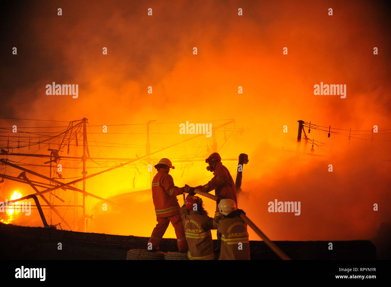 Jakarta, Indonesia. 23rd Feb, 2019. Firefighters try to extinguish the burning fishing boats at Muara Baru Port in Jakarta, Indonesia, Feb. 23, 2019. Credit: Zulkarnain/Xinhua/Alamy Live News Stock Photo