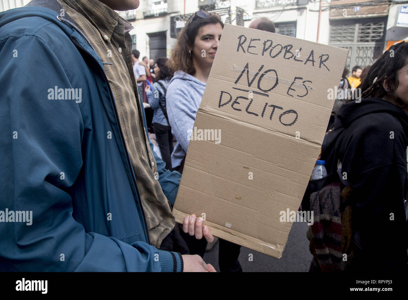 Madrid, Spain. 23rd Feb, 2019. A protester seen holding a placard saying Repopulate is not a crime during the protest.Thousands of people protest in Madrid in support of the Eco village of Fraguas in Guadalajara so that it will not be demolished by the government of Castilla La Mancha. Credit: ZUMA Press, Inc./Alamy Live News Stock Photo