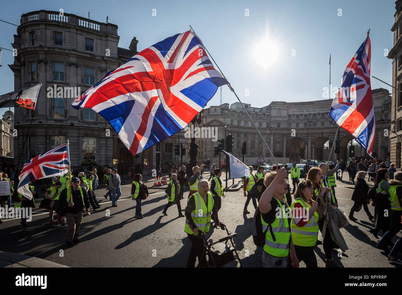London, UK. 23rd February, 2019. Pro-Brexit protesters calling themselves the 'Yellow Vests UK' movement block roads and traffic whilst protest marching through Westminster. The right-wing nationalists briefly clashed with police and angry drivers whilst aggressively demanding Britain leave the EU without an exit deal. Credit: Guy Corbishley/Alamy Live News Stock Photo