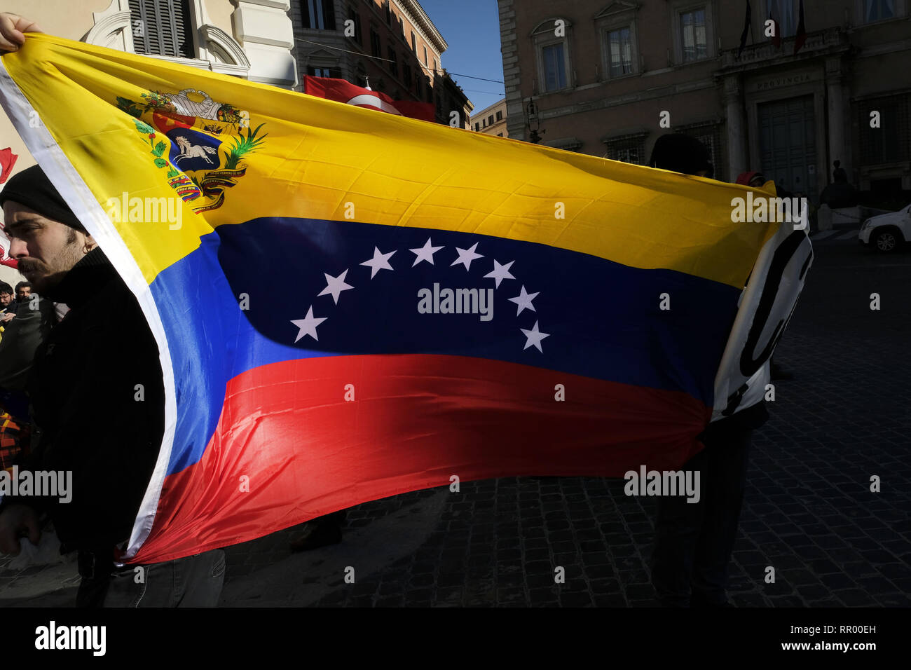 Rome, Italy. 23rd Feb, 2019. Demonstrations in favor of Nicolas Maduro. The protesters waving flags of the PCI (Italian Communist Party) shouting that in Venezuela there is no dictatorship but oil. During the event a flag of the European community was soiled with oil and tomato sauce to represent blood. Credit: Danilo Balducci/ZUMA Wire/Alamy Live News Stock Photo