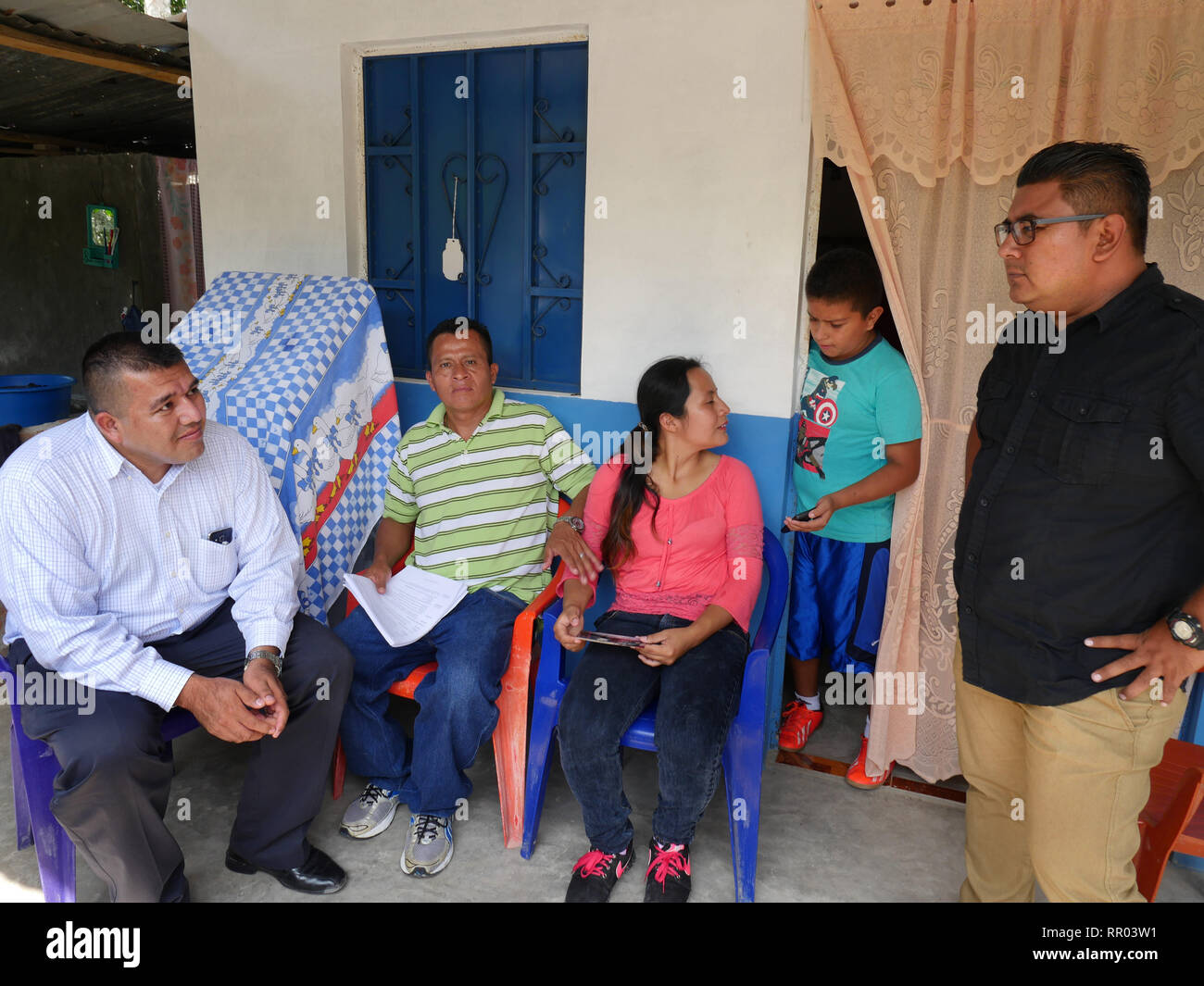 EL SALVADOR  Santos Pastor Paulino, 43, with his daughter Alexandra Yamileth, 20, at their home near Cuscatlan, being visited by Luis Lopez of COFAMIDE and Santiago Salinas of SEAL. Stock Photo