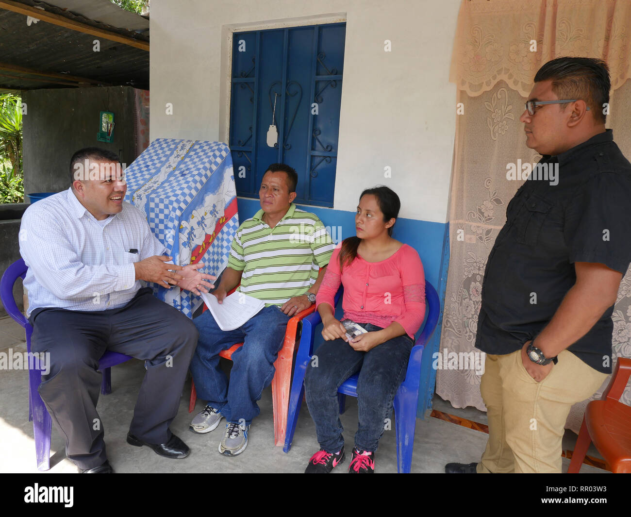 EL SALVADOR  Santos Pastor Paulino, 43, with his daughter Alexandra Yamileth, 20, at their home near Cuscatlan, being visited by Luis Lopez of COFAMIDE and Santiago Salinas of SEAL. Stock Photo