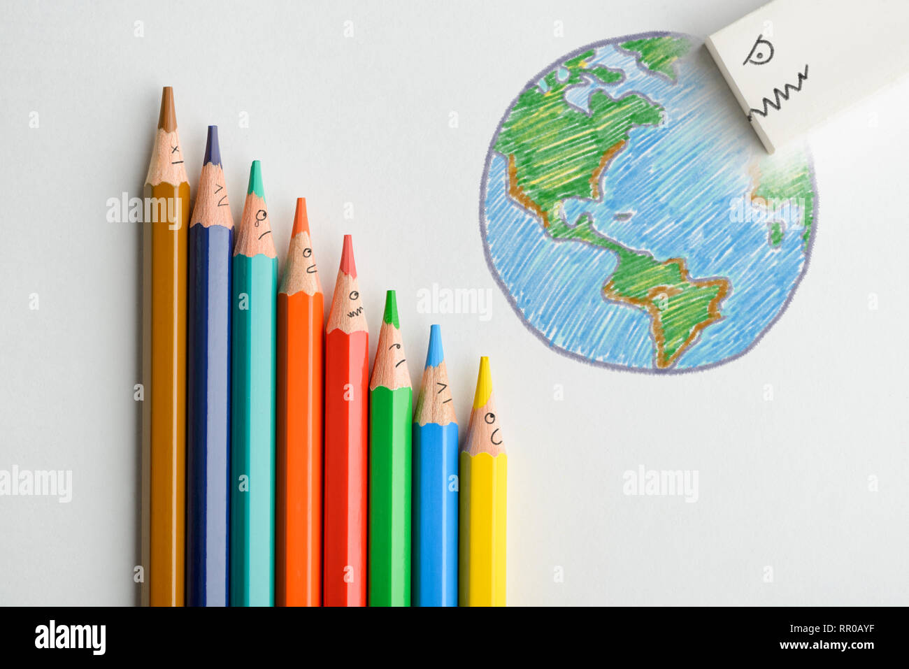 Surprised colored pencils watching as evil eraser destroying hand drawn