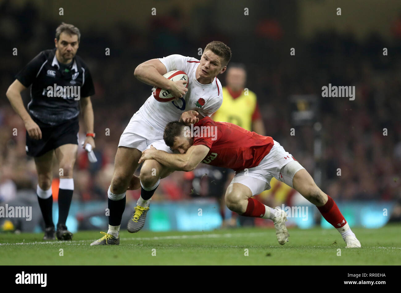 England S Owen Farrell Left Is Tackled By Wales Gareth Davies During The Guinness Six Nations Match At The Principality Stadium Cardiff Stock Photo Alamy