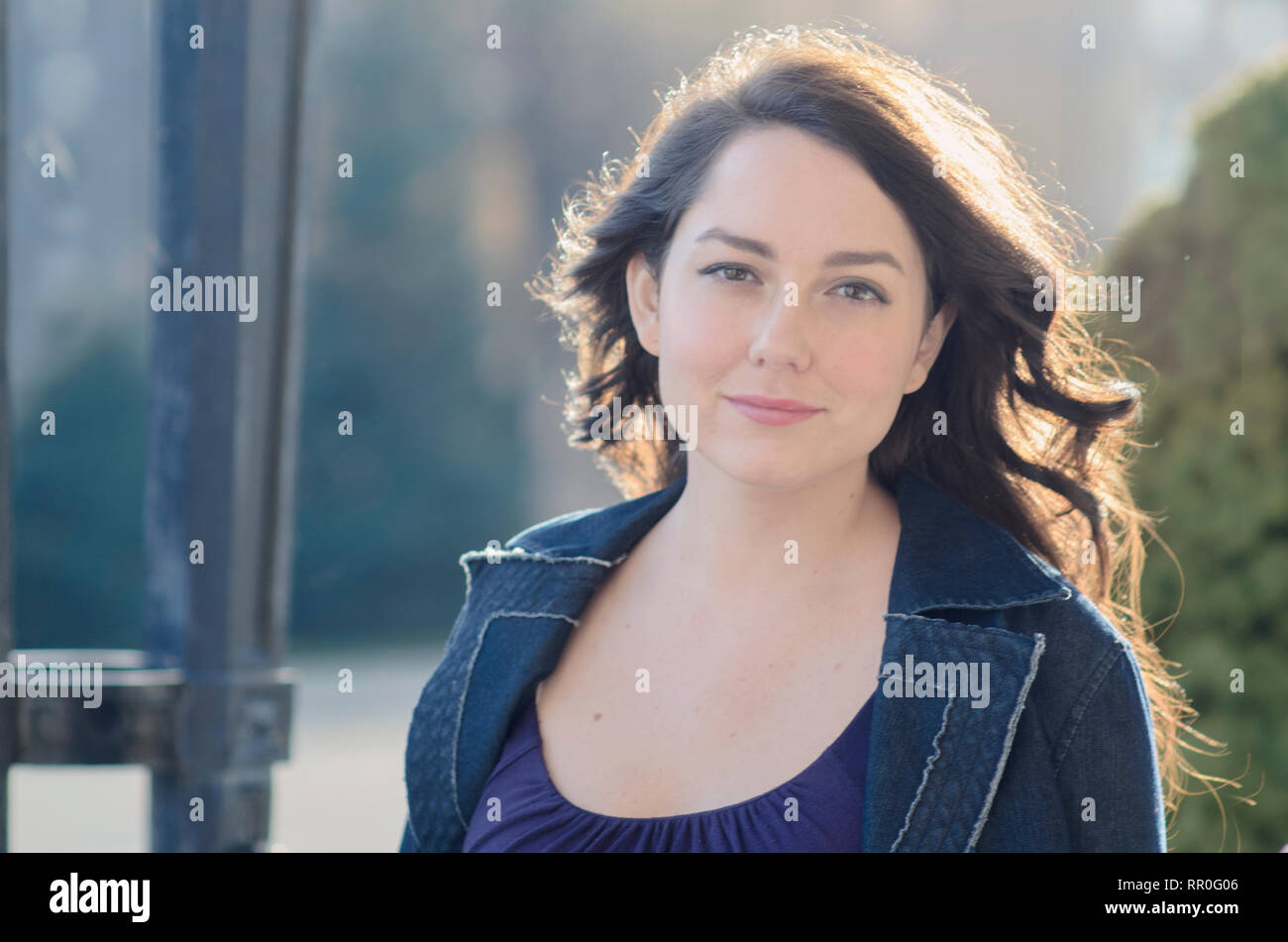 Pretty Woman with long dark hair outside Stock Photo