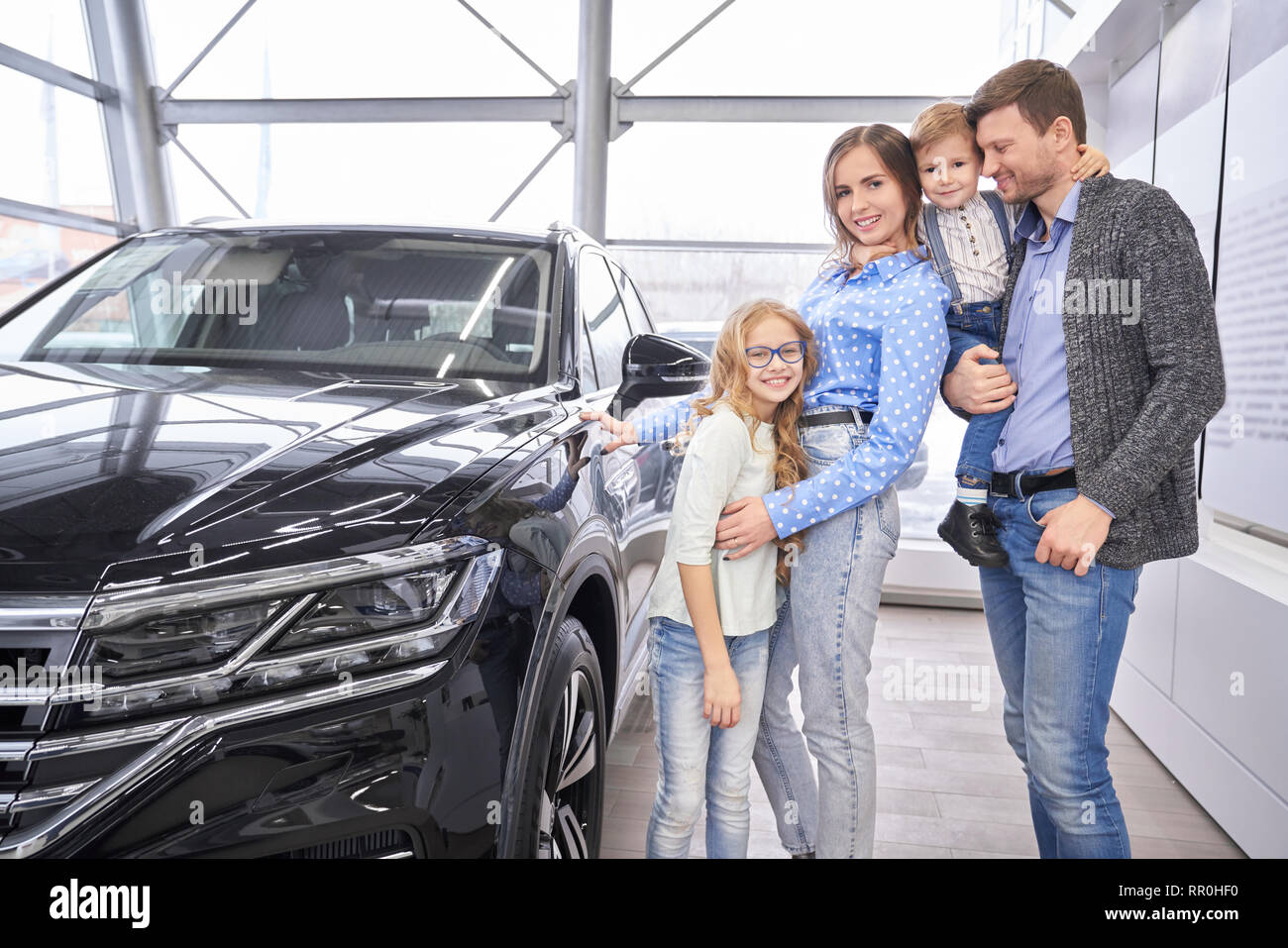 photo Standing Pose For Boys With Car https www alamy com cheerful happy family potential buyers of car standing in showroom of car dealership parent and children posing near black expensive automobile looking at camera and smiling image237885620 html