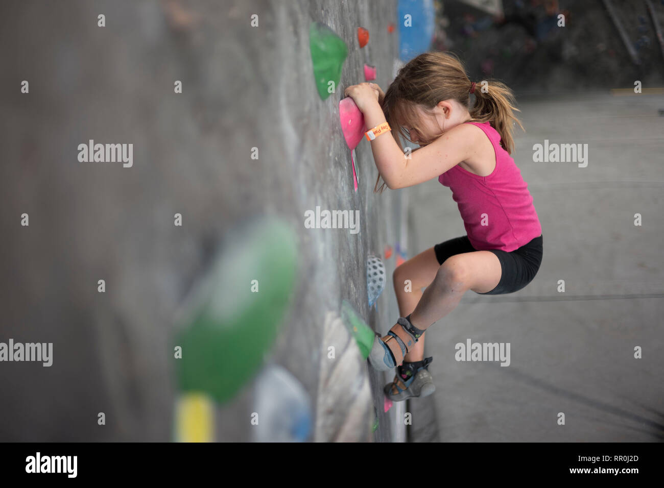 Young Girl climbing at indoor climbing gym Stock Photo Alamy