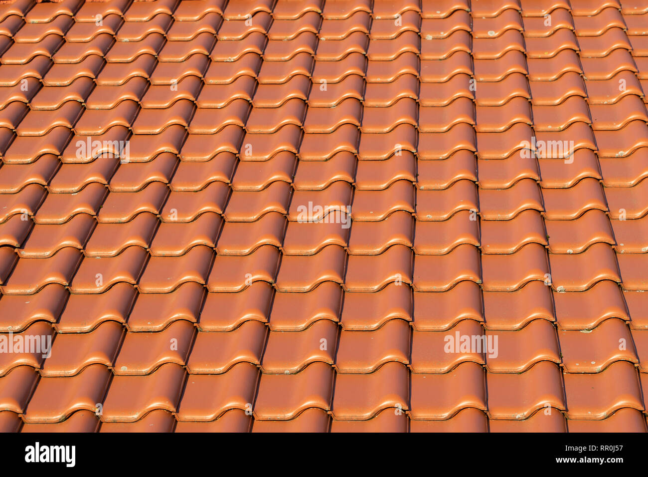 red roof tiles in rows on a house Stock Photo