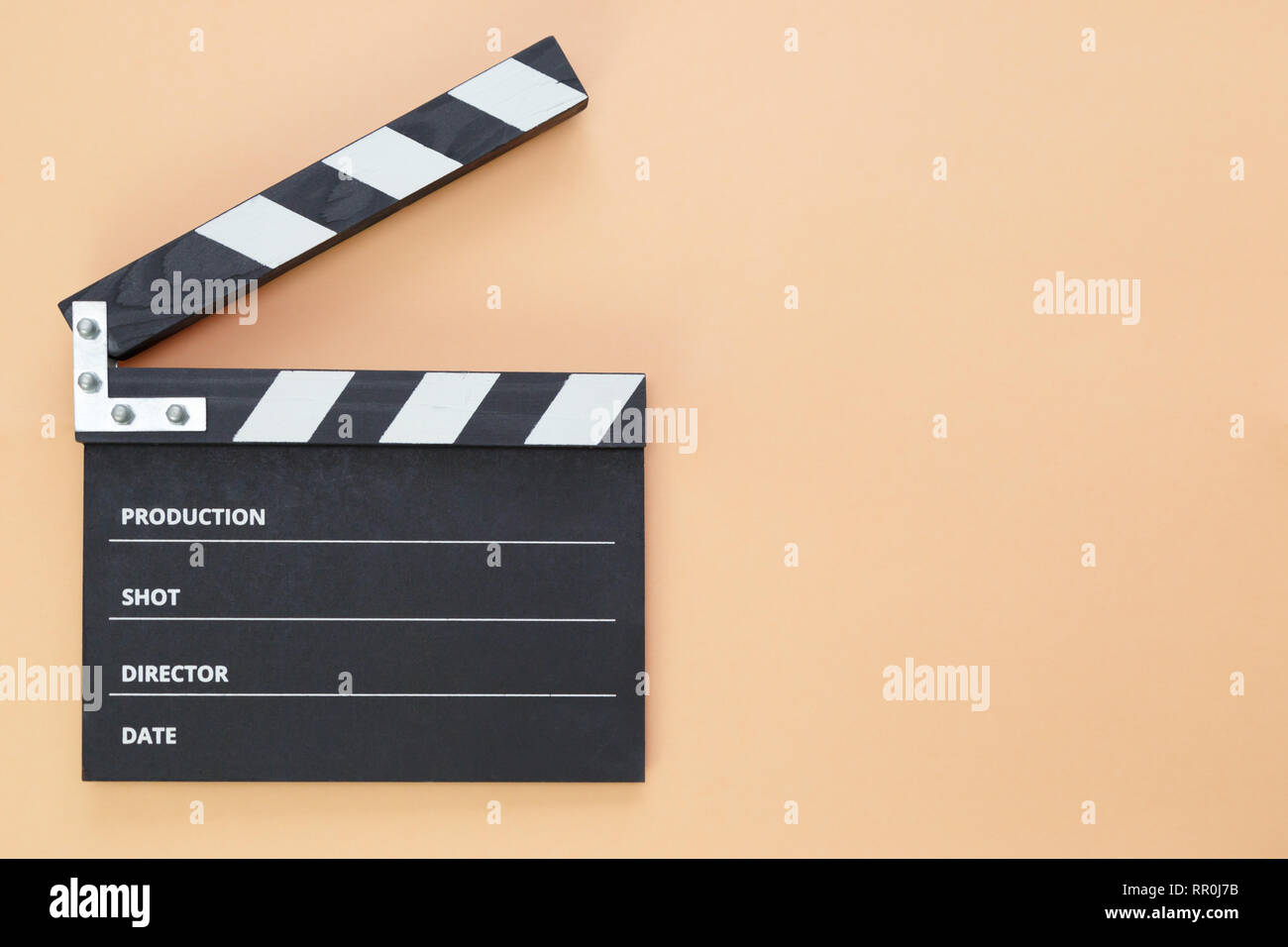 black clapperboard isolated on color background, flat lay Stock Photo