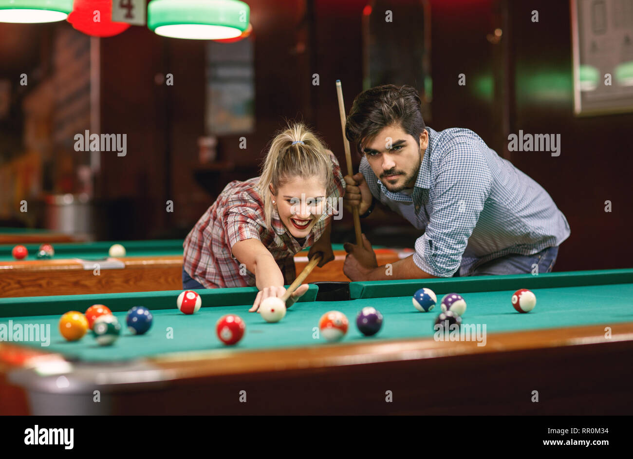 playing billiardsYoung couple shooting pool ball Stock Photo Alamy