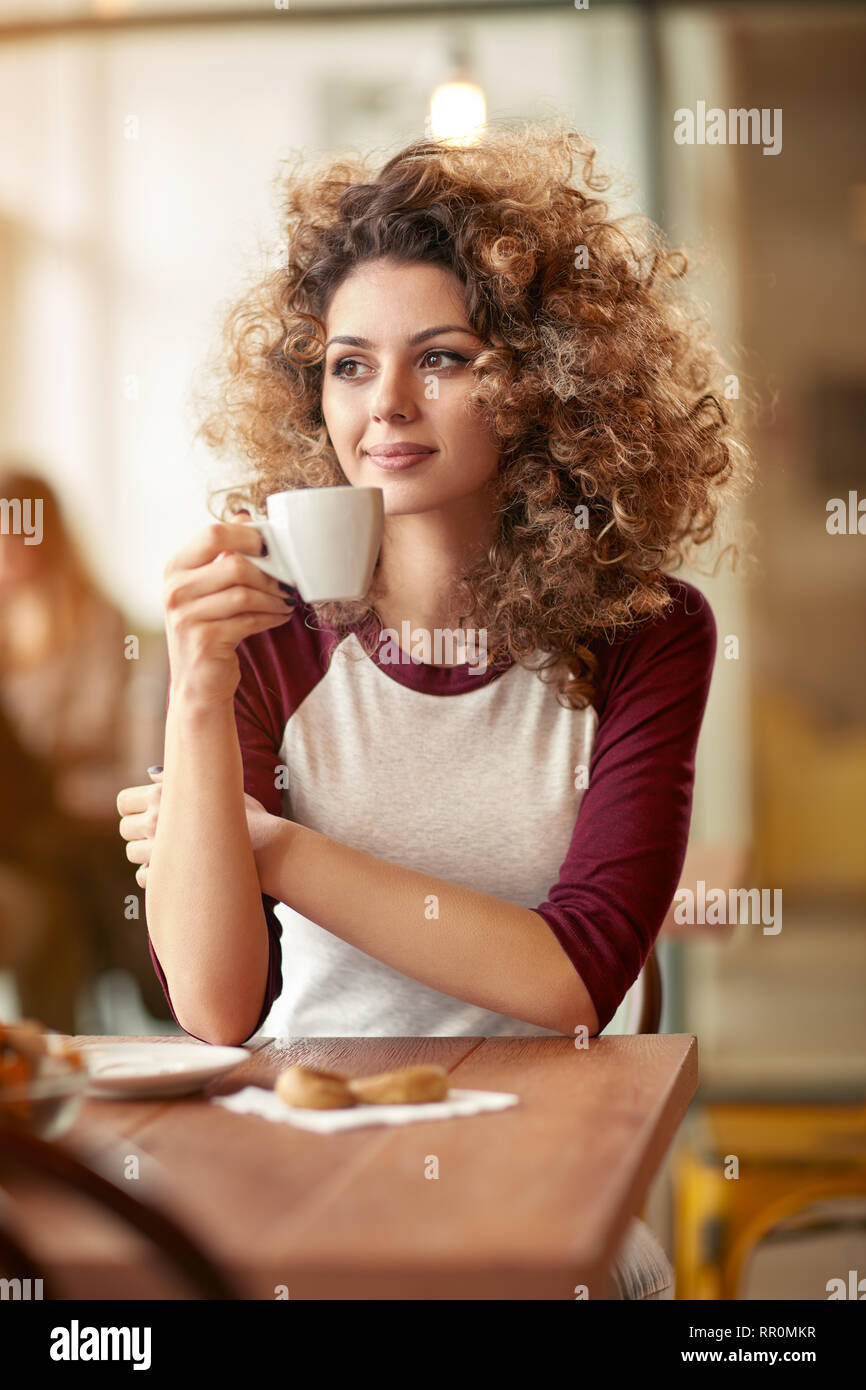 Curly girl have breakfast in restaurant Stock Photo