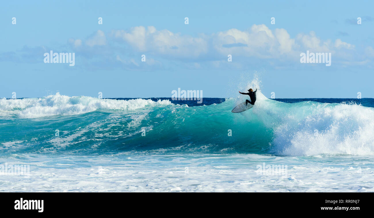 Surf board rider catching a wave Port Fairy Victoria Australia Stock Photo