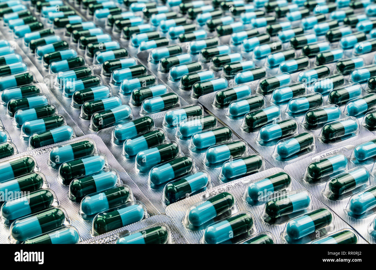 Closeup greenblue antibiotic capsule pills in blister pack