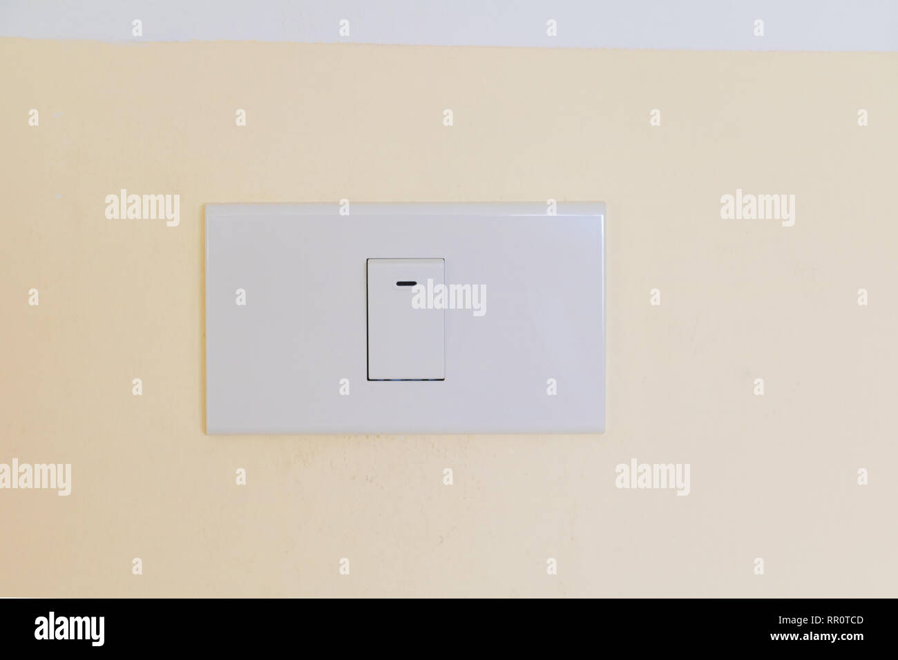 electricity switch white on wall yellow Stock Photo