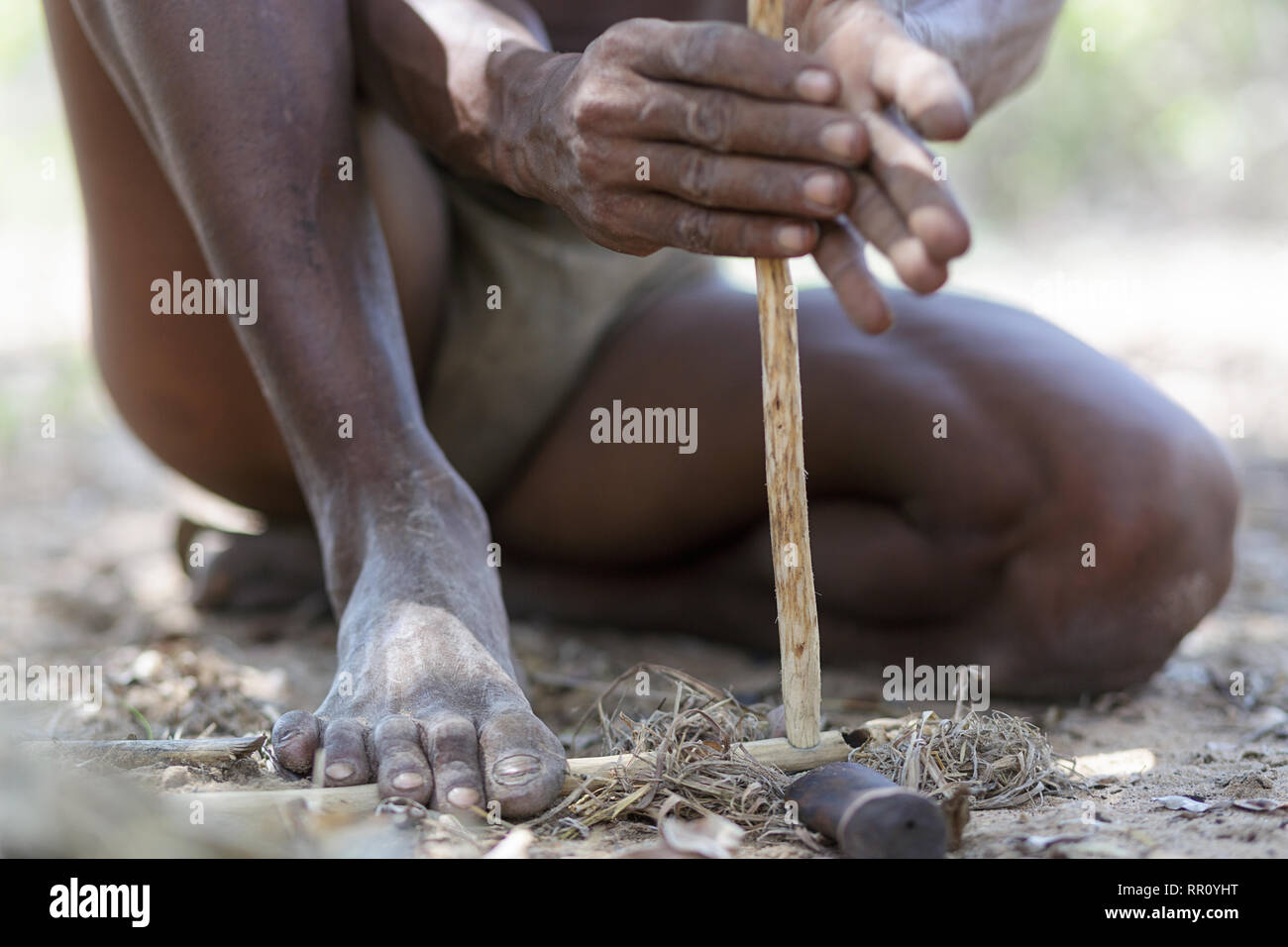 Bushmen of the San people lighting fire, Kalahari, Namibia, Africa Stock Photo