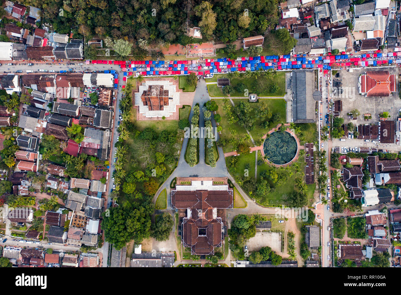 (view from above) Stunning aerial view of the beautiful Haw Pha Bang Temple and the Royal Palace National Museum with colored night market tents. Stock Photo