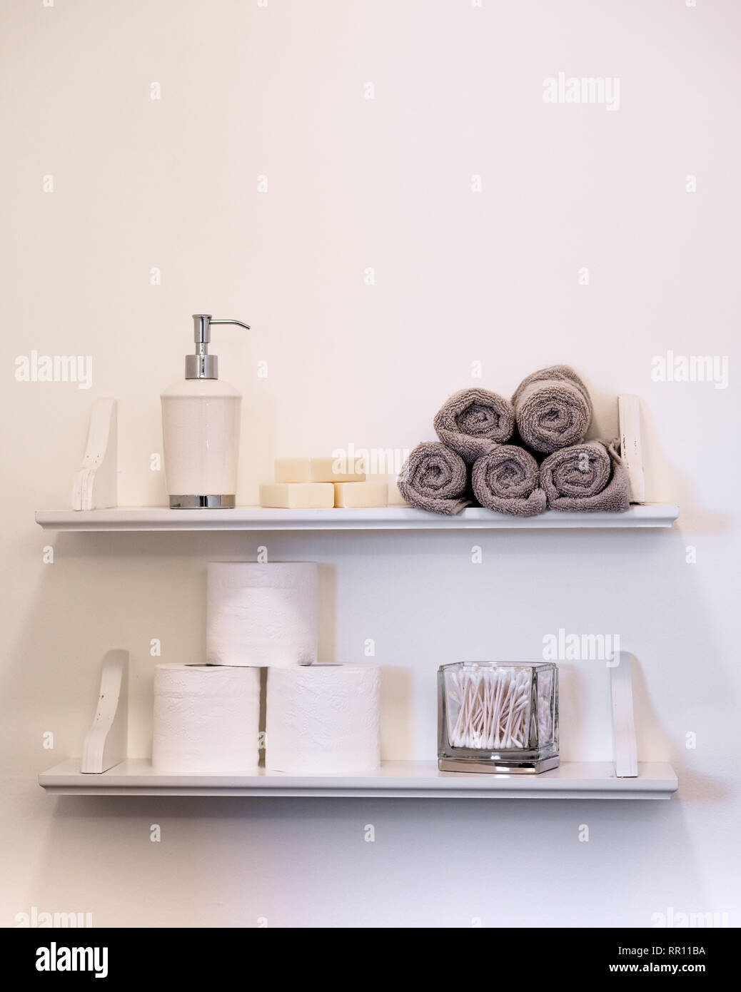 Clean white bathroom shelving and neutral hygiene objects with monotone