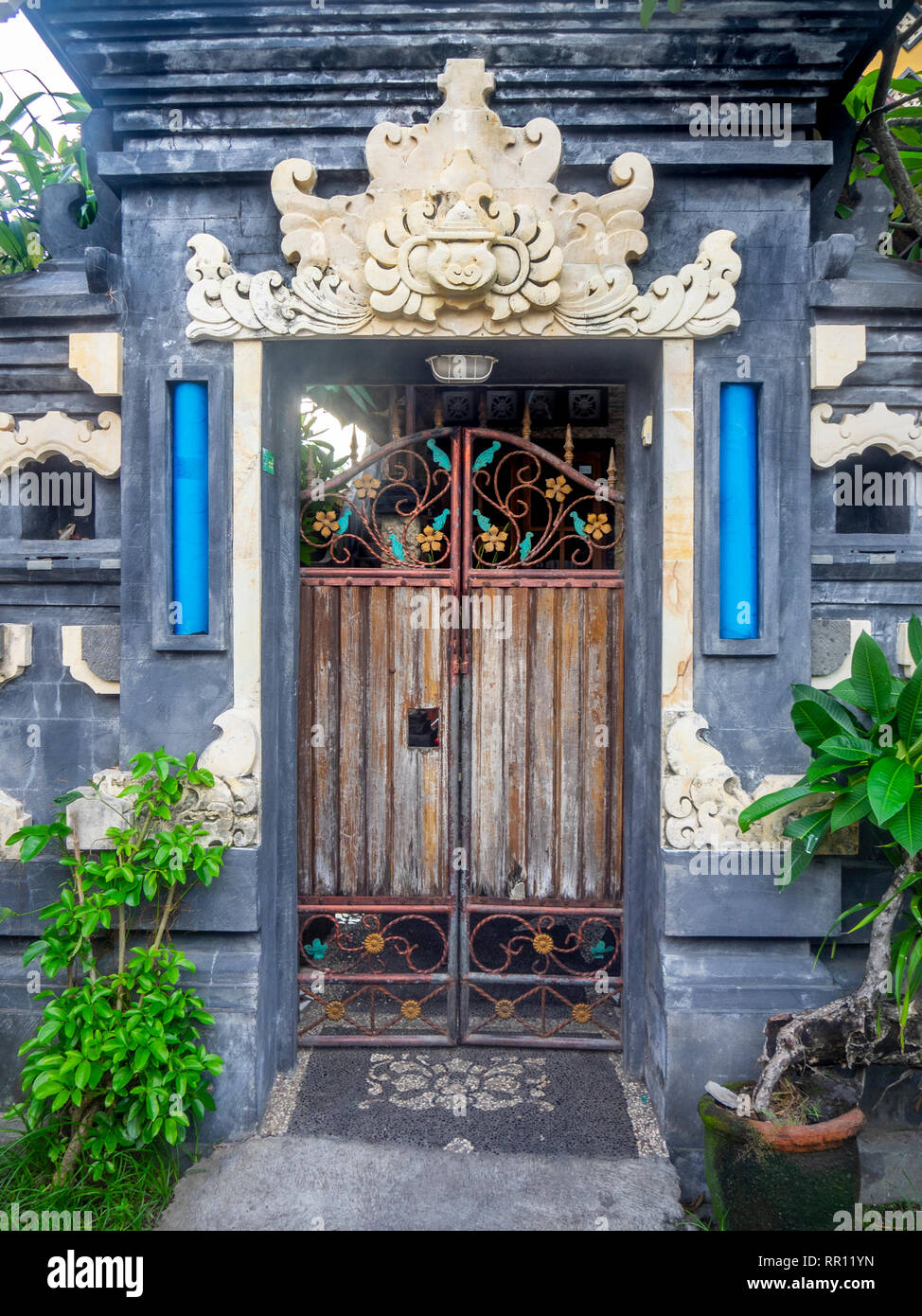 Ornate rustic gate at entrance to pura Hindu Temple in Jimbaran Bay Bali Indonesia. Stock Photo