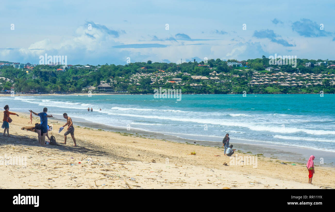 Tourists on the beach at Jimbaran Bay Bali Indonesia. Stock Photo
