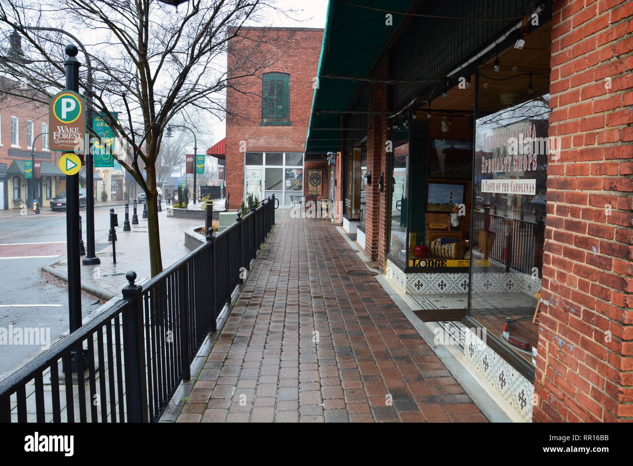 A rainy morning keeps shoppers away in the business district of historic downtown Wake Forest, North Carolina. Stock Photo