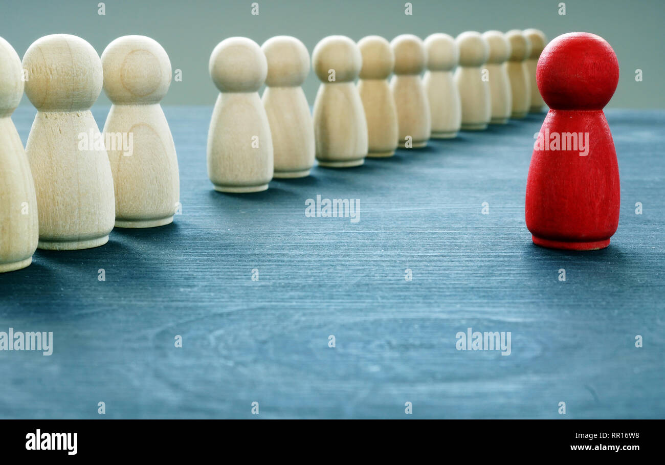 Be unique and different. Red figurine is stand out from the crowd. Stock Photo