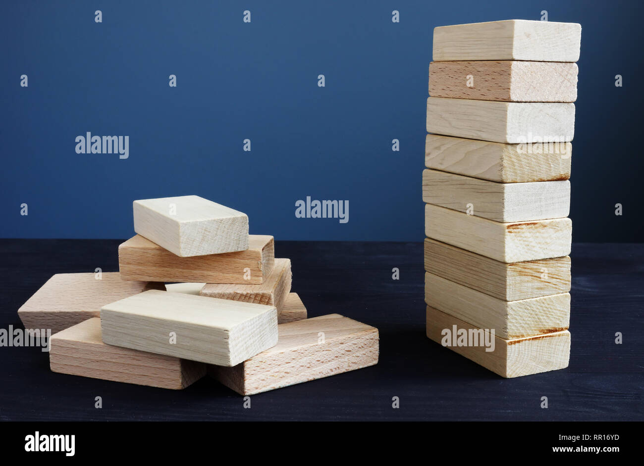 Organization, strategy and risk in business concept. Tower and piled up from wooden bricks. Stock Photo