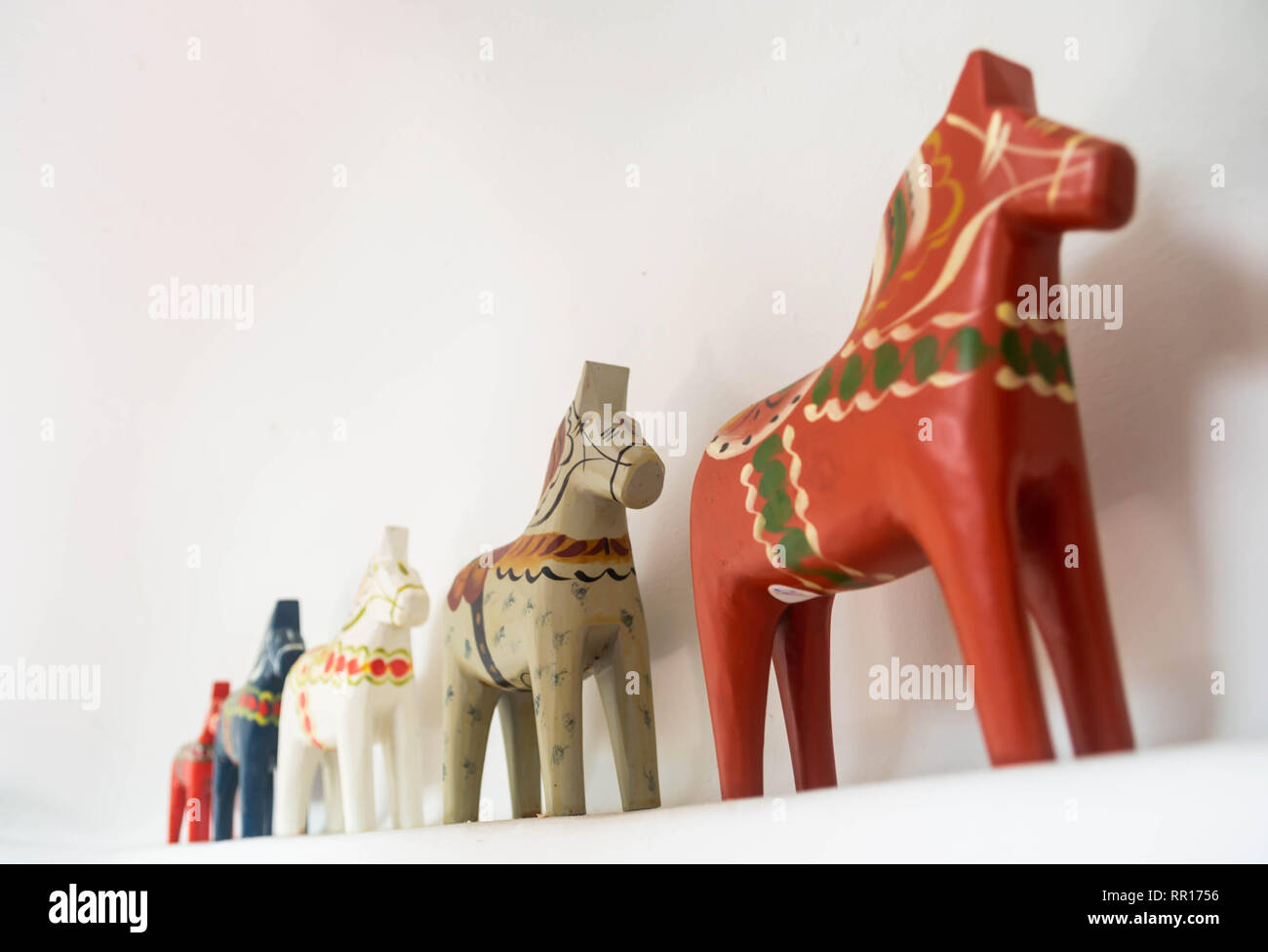 Multicolored Swedish Dalahorses lined up next to each other. Stock Photo