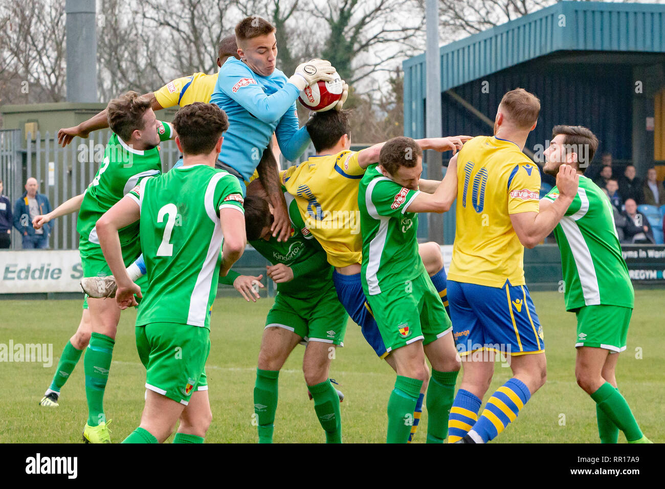 Finnish goalkeeper, William Jaaskelainen, grabs the ball in a goalmouth scrabble when Warrington Town FC host Nantwich Town FC in a football match in  Stock Photo