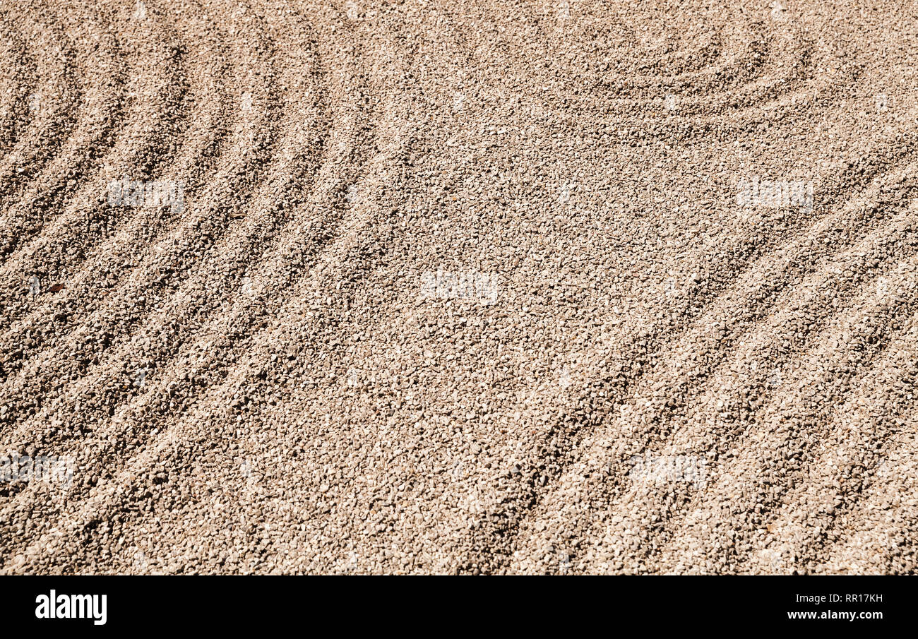Zen patterns on the sand in the Japanese rock garden, background photo Stock Photo
