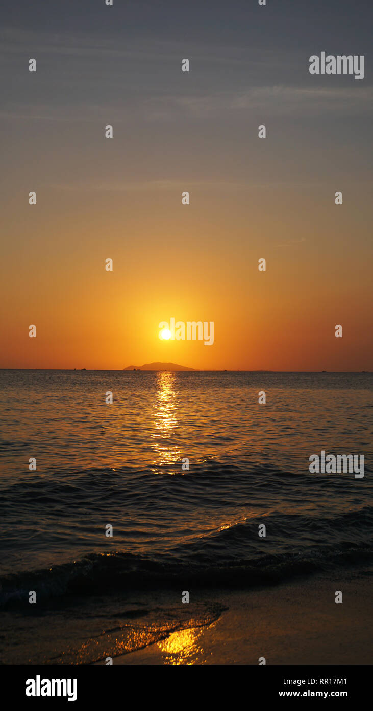 Bright sunset under the sea with yellow red gradient colors Vertical