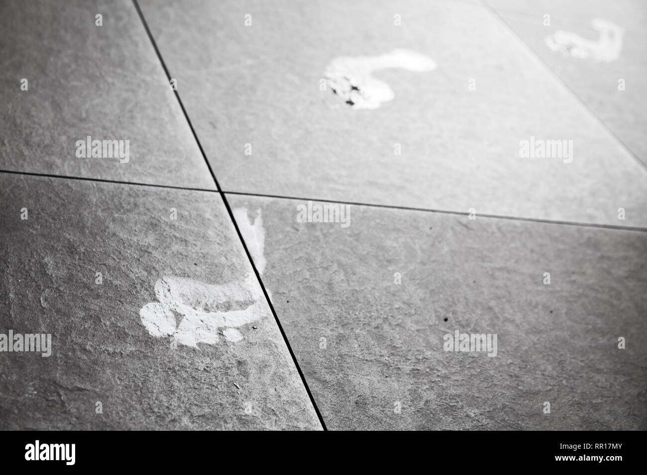 White wet barefoot human footprints over stone floor, background photo Stock Photo