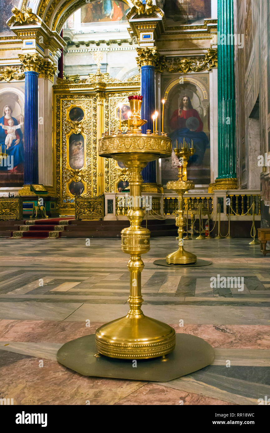 Fragment of rich decorated interior of ancient Saint Isaac's orthodox cathedral, large standing candlestick Stock Photo