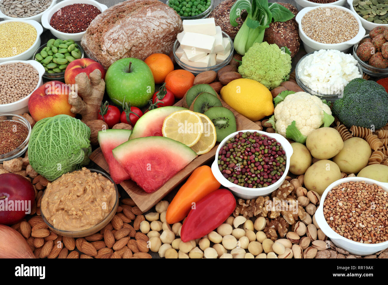 Large vegan health food selection with fruit, vegetables, bean curd,  legumes, nuts, pasta, cereals, bread, grains, almond yoghurt & peanut  butter Stock Photo - Alamy