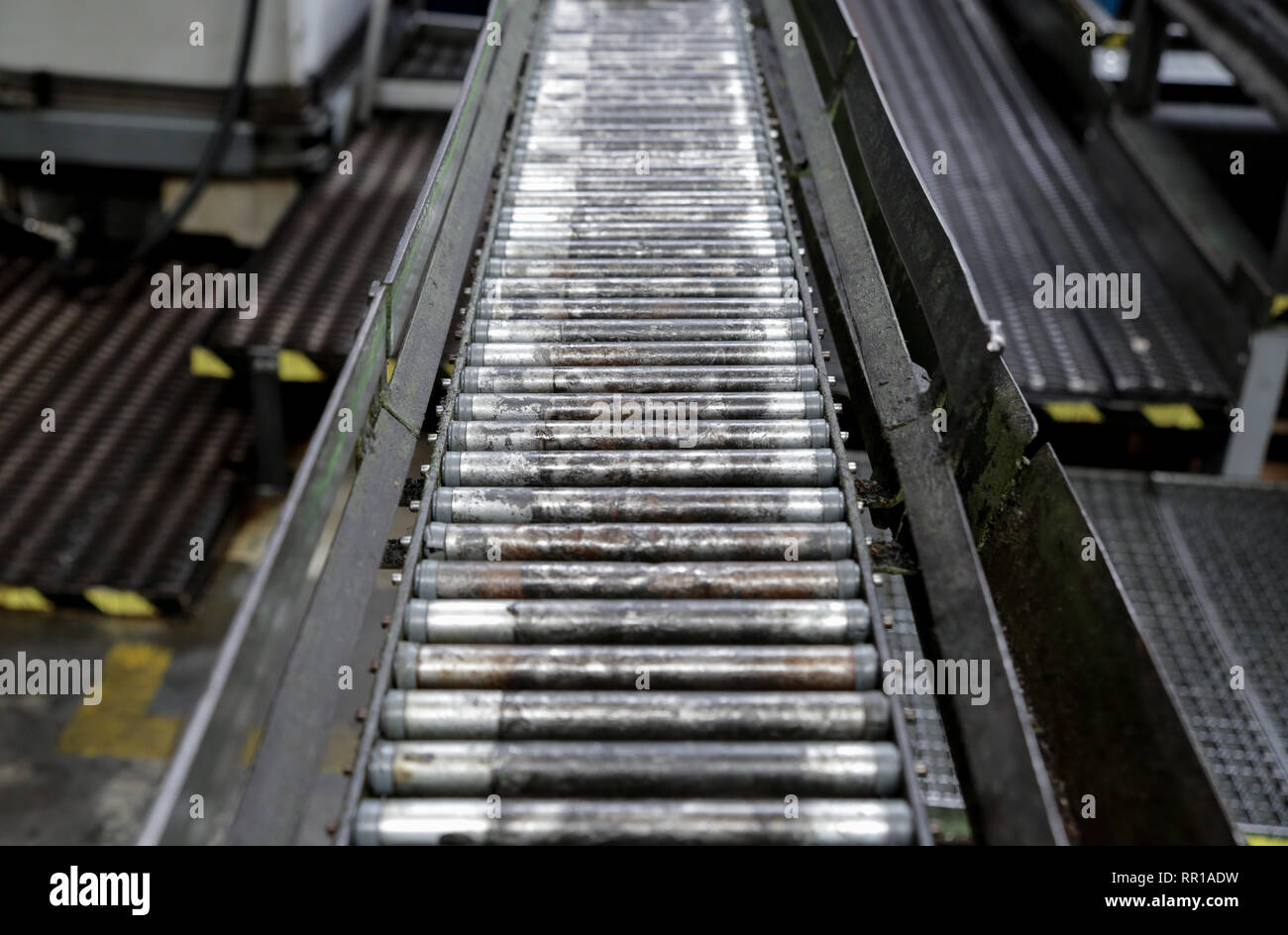 A roller conveyor chain and roller conveyor belt Stock Photo Alamy
